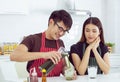 A handsome is taking care his cute girlfriend by pouring green tea for her