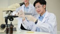 Handsome Asian male scientist working in the laboratory with his colleague Royalty Free Stock Photo