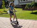 Handsome tall young man trying out his new electric kick scooter Royalty Free Stock Photo