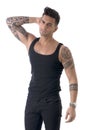 Handsome tattooed young man wearing grey t-shirt, standing