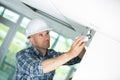 handsome technician installing security camera system in enterprise Royalty Free Stock Photo