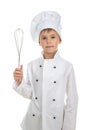 Handsome teen boy in chef uniform with a cooking whisk, on white background.