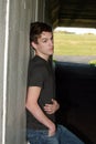 Handsome teen guy leaning on wall