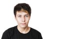 A handsome teenage boy in a black t-shirt on a white background. He has beautiful sad eyes and painted hair Royalty Free Stock Photo