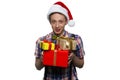 Handsome teenage boy is giving presents for xmas. Royalty Free Stock Photo