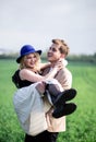 Handsome teenage boy holding and lifting up his girlfriend Royalty Free Stock Photo