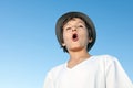 Handsome teenage boy standing outside against a blue sky Royalty Free Stock Photo