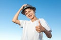 Handsome teenage boy standing outside against a blue sky Royalty Free Stock Photo