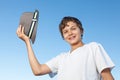 Handsome teenage boy standing outside against a blue sky Royalty Free Stock Photo