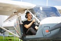 Outdoor shot of young man in small plane cockpit Royalty Free Stock Photo