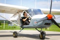 Young man in small plane cockpit outdoors Royalty Free Stock Photo