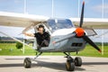 Young man in small plane cockpit outdoors Royalty Free Stock Photo