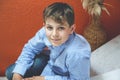 Handsome Teenager Boy Poses Indoors, Exuding Confidence and Style in a Captivating Portrait. Happy Preteen Child.