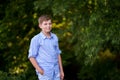 Handsome Teenager Boy Poses Outdoors, Exuding Confidence and Style in a Captivating Portrait. Happy Preteen Child.