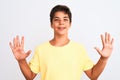 Handsome teenager boy standing over white isolated background showing and pointing up with fingers number ten while smiling Royalty Free Stock Photo