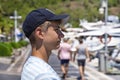 Handsome teenager guy enjoying the view of marina.