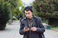 Handsome teenager texting on a mobile phone Royalty Free Stock Photo