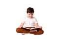 Handsome ten year old boy with book over white background. Royalty Free Stock Photo