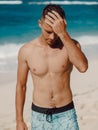 Handsome topless male model vacation on tropical beach