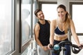 Handsome trainer and beautiful woman exercising