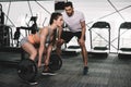 handsome trainer looking at athletic sportswoman