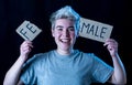 Transgender teenager breaking the word FEMALE into MALE. Gender identity and human rights concept