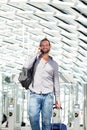 Handsome travel man talking on phone with luggage Royalty Free Stock Photo