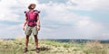 handsome traveler with backpack standing