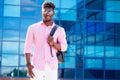 Handsome trendy African Americans rastaman male dreadlocks hair with glasses in stylish clothes colorful T-shirt with a Royalty Free Stock Photo