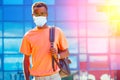 Handsome trendy African Americans nerd male with glasses in stylish clothes colorful T-shirt with a backpack on the Royalty Free Stock Photo