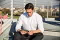 Handsome trendy man looking down at a tablet Royalty Free Stock Photo