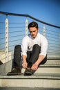 Handsome trendy man sittiing on stairs, outdoor Royalty Free Stock Photo