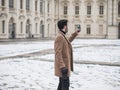 Handsome trendy man using cell phone in winter day Royalty Free Stock Photo