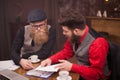 Handsome two businessmen having a meeting in a coffee shop Royalty Free Stock Photo