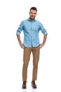 Handsome unshaved guy with chino pants and sneakers smiling Royalty Free Stock Photo