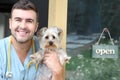 Handsome veterinarian holding Yorkshire Terrier Royalty Free Stock Photo