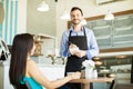 Handsome waiter doing his job Royalty Free Stock Photo