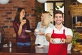 Handsome waiter handing a cup of coffee