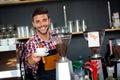 Handsome waiter offering a cup of coffee