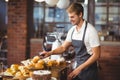 Handsome waiter picking up a roll