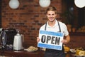Handsome waiter presenting open sign Royalty Free Stock Photo