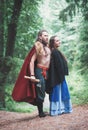 Handsome Warrior Viking man with beautiful medieval woman outdoor