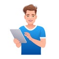Handsome white young man holds a tablet computer in his hand. Internet surfing and working in a mobile application