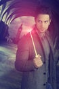 Handsome wizard holding a magic wand Royalty Free Stock Photo