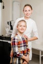 a handsome woman doctor hugs a little patient.