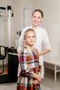 a handsome woman doctor hugs a little patient.