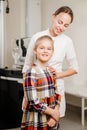 a handsome woman doctor hugs a little patient.