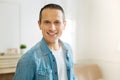 Emotional young man feeling happy while working at home and smiling Royalty Free Stock Photo