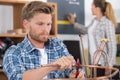 Handsome worker cutting copper pipe Royalty Free Stock Photo