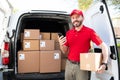 Handsome worker making a delivery at a shipping address